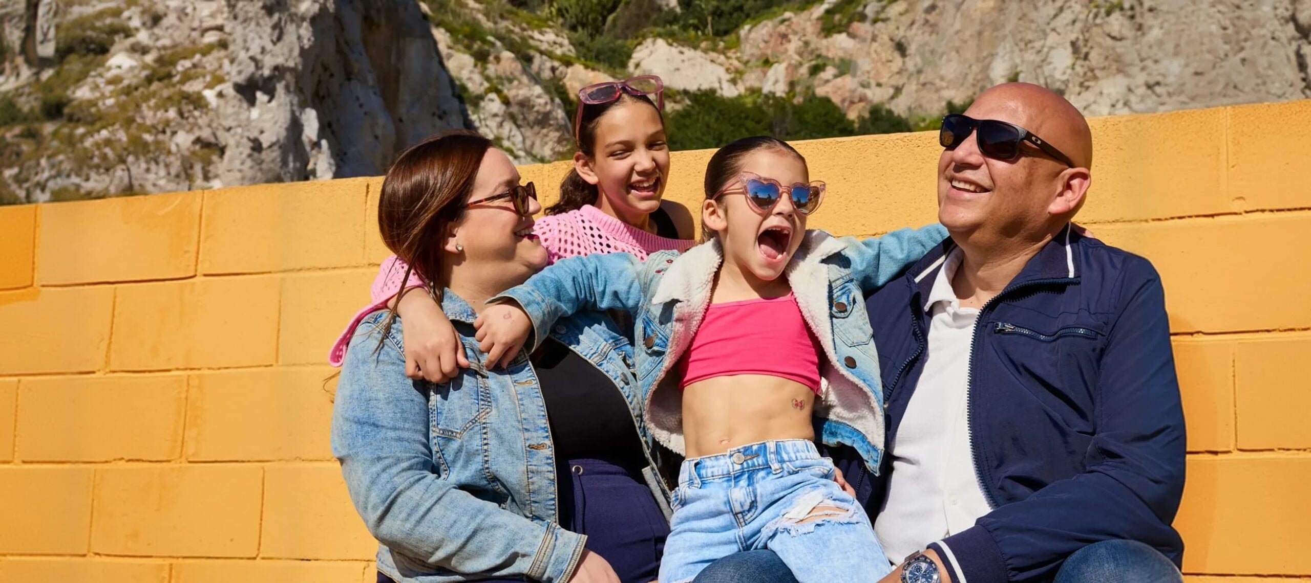 family smiling out in the sun