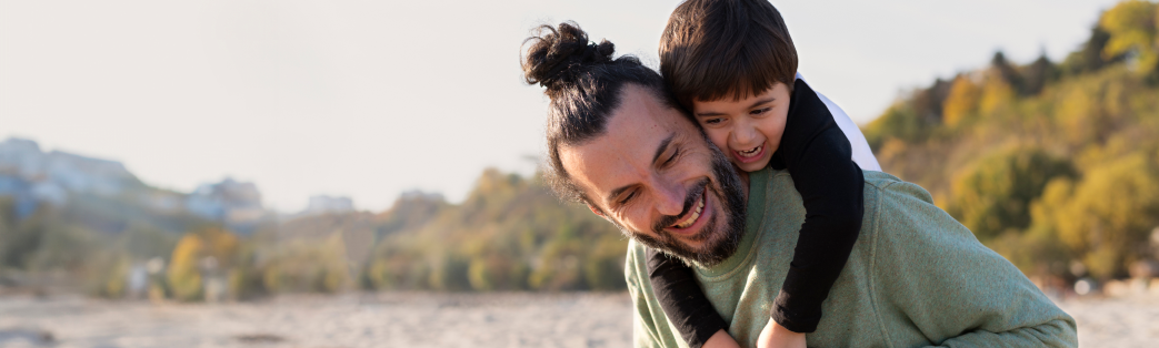 Image of a man and a child on the beach