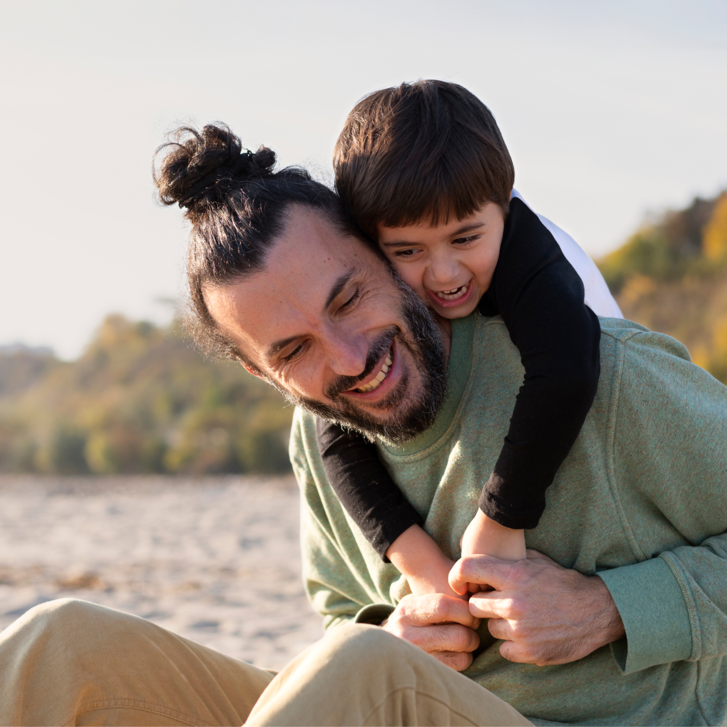 Image of a man and a child on the beach