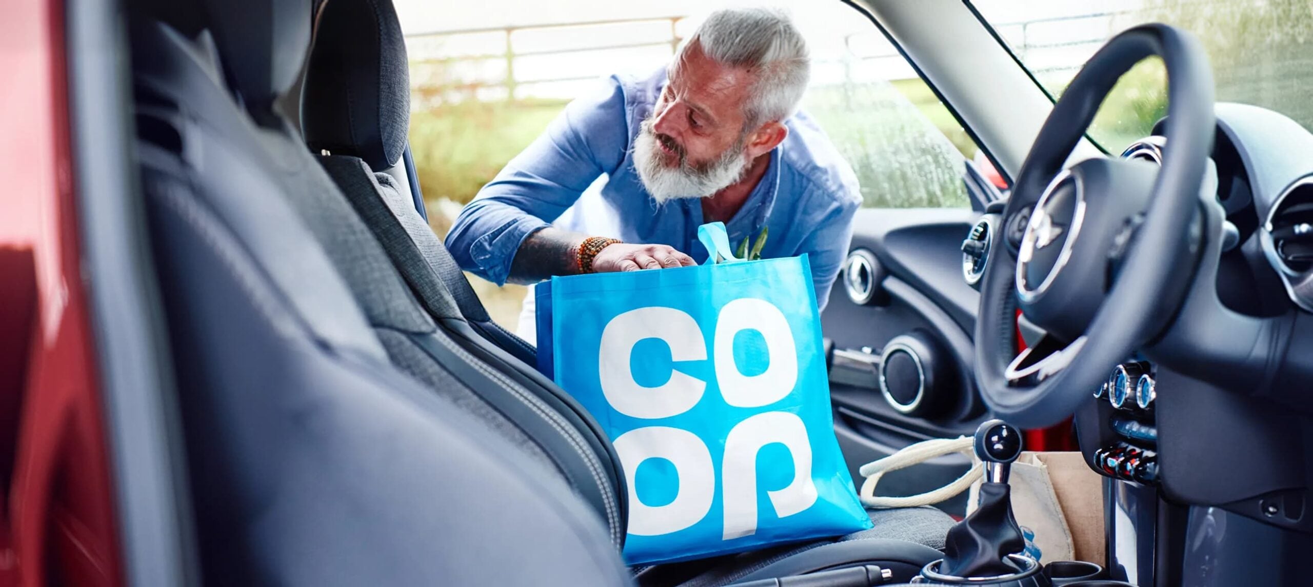 man loading a bag into a car