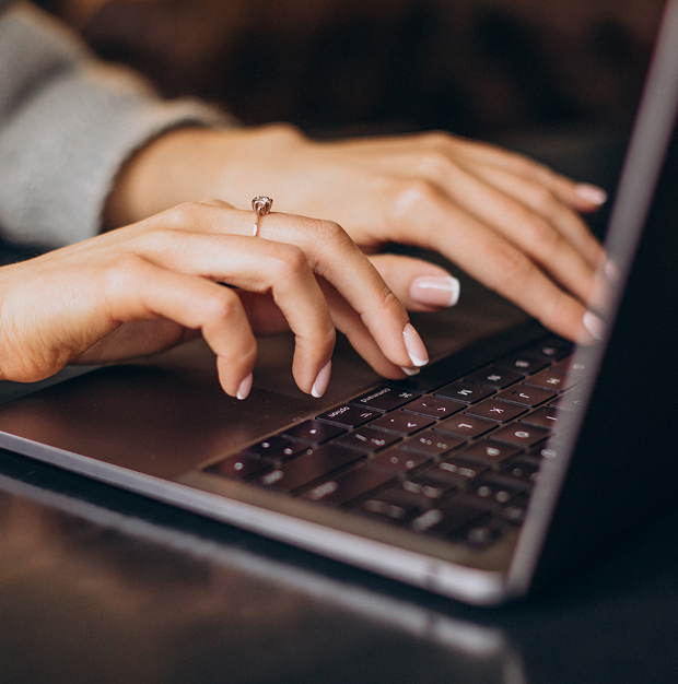 woman typing on the laptop