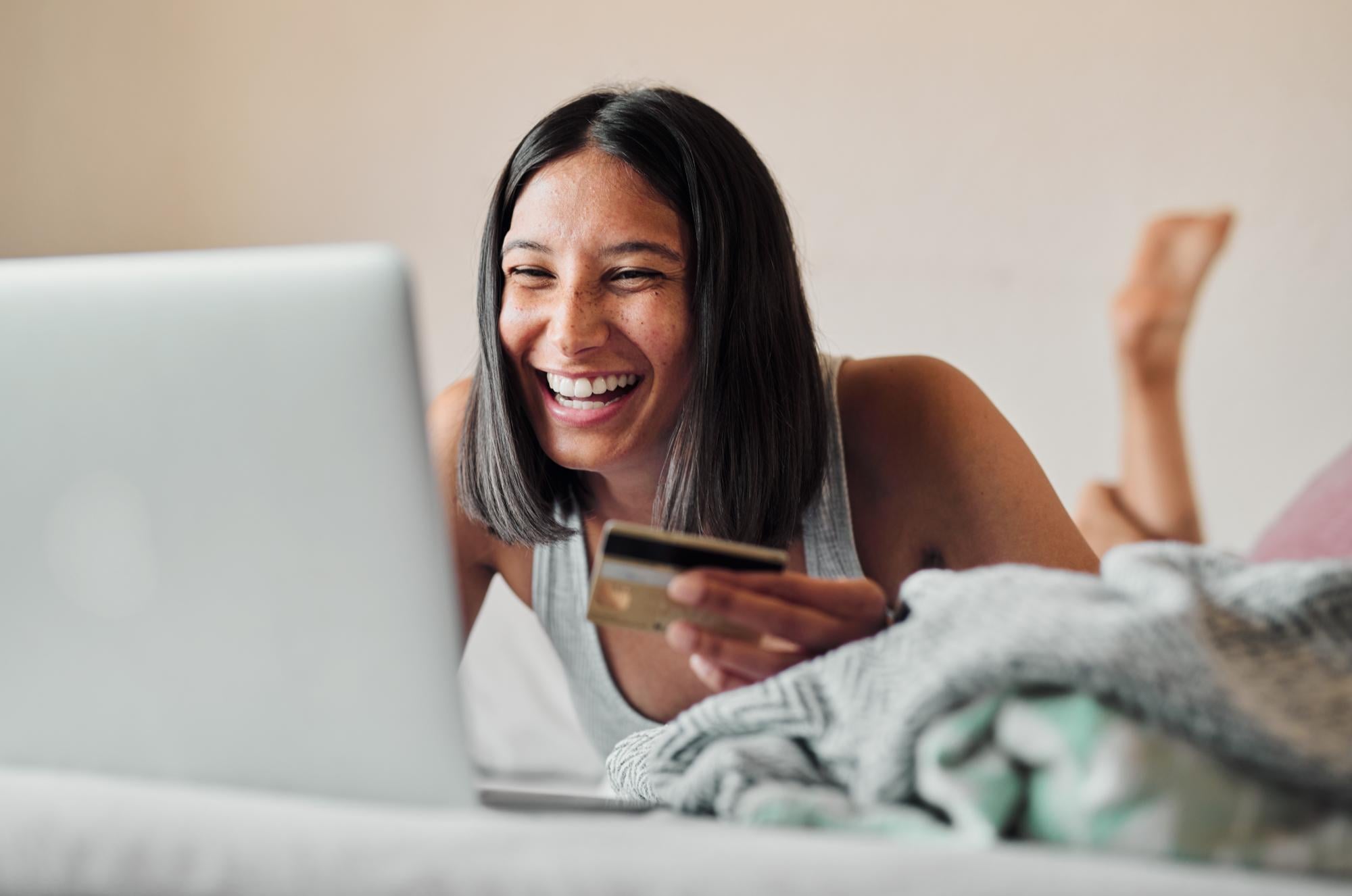 woman on the laptop on the bed
